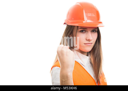 Young girl engineer holding her left fist up being ready to punch someone on white background with copyspace Stock Photo