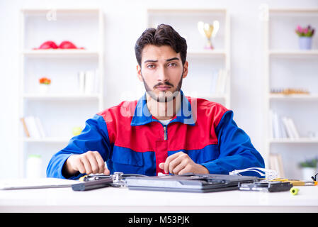 Repairman working in technical support fixing computer laptop tr Stock Photo