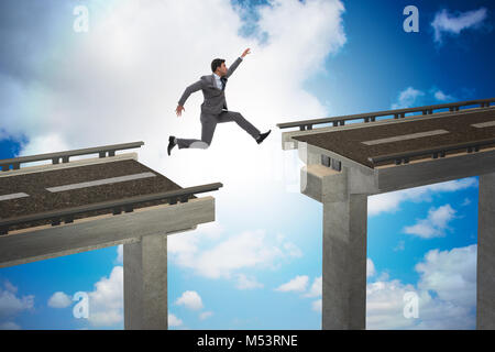 Young businessman jumping over the bridge Stock Photo