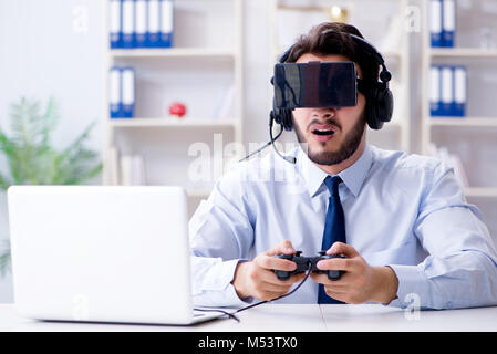 Businessman gamer in office playing games Stock Photo