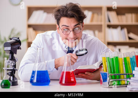 Mad crazy scientist doctor doing experiments in a laboratory Stock Photo