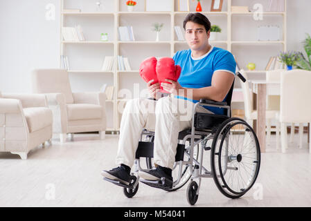 Disabled boxer at wheelchair recovering from injury Stock Photo