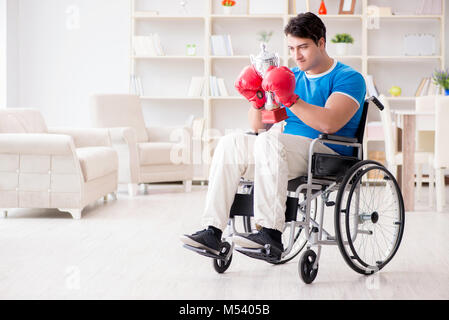 Disabled boxer at wheelchair recovering from injury Stock Photo