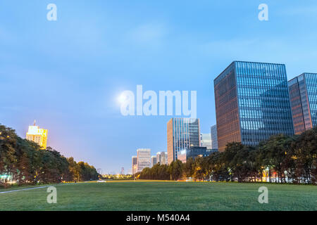 modern buildings with green space in nightfall Stock Photo