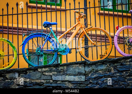 Old rusty colourfully painted vintage bicycle Stock Photo