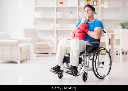 Disabled boxer at wheelchair recovering from injury Stock Photo