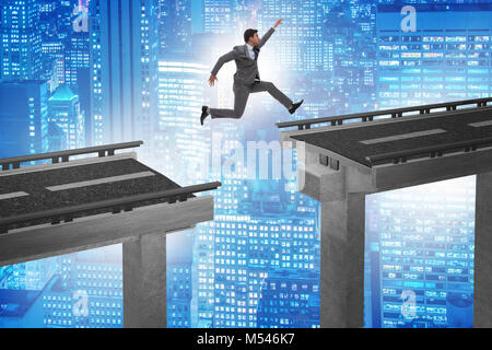 Young businessman jumping over the bridge Stock Photo