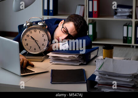 Businessman falling asleep during long hours in office Stock Photo