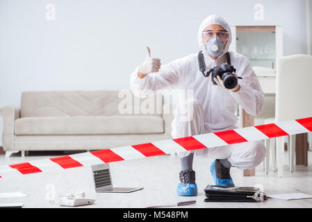Forensic expert at crime scene doing investigation Stock Photo