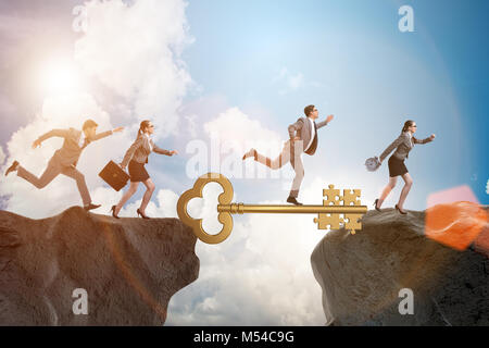 Business people chasing each other towards key to success Stock Photo