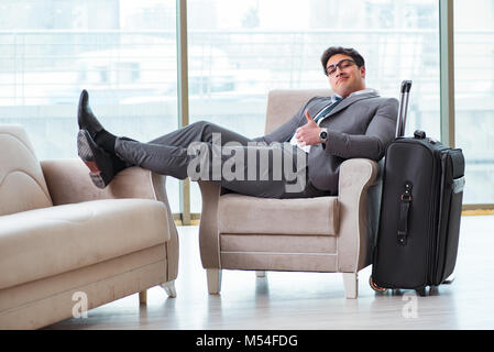 Young businessman in airport business lounge waiting for flight Stock Photo