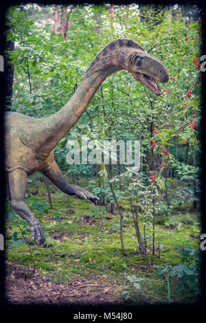 Life sized dinosaur statue in a forest Stock Photo