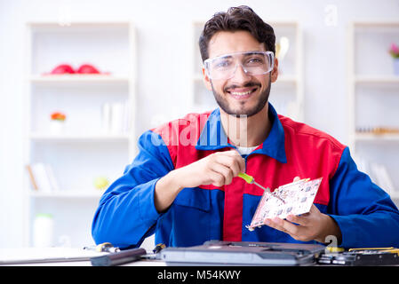 Repairman working in technical support fixing computer laptop tr Stock Photo