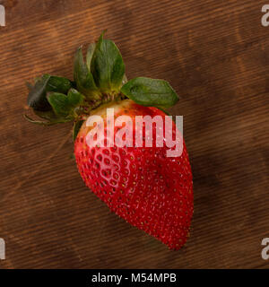 Fresh Red Strawberries Shot From Directly  Above in Studio on Brown Wooden Background Stock Photo