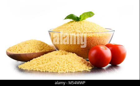 Bowl of uncooked couscous isolated on white background Stock Photo