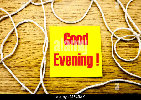Good Evening. word on yellow sticky note in wooden background. Bussines concept. Motivational. Stock Photo