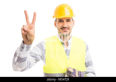 Constructor or builder showing victory gesture as confidence concept isolated on white background Stock Photo