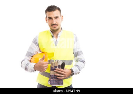 Confident young building contractor showing thumbsup and smiling isolated on white background Stock Photo