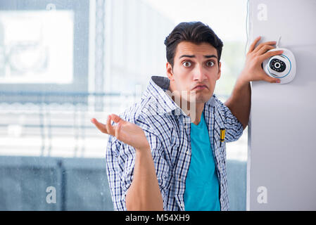 The man installing surveillance cctv cameras at home Stock Photo