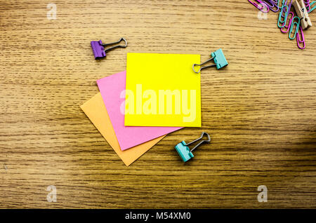 Paper sticker note on wooden background. Blank forms for workers notes. Stock Photo