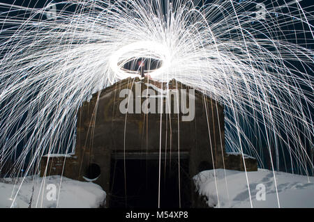 steel wool photo 2018. white sparks. Winter creative landscape. Hidden in the woods the entrance to a secret military bunker, an echo of the cold war. Stock Photo