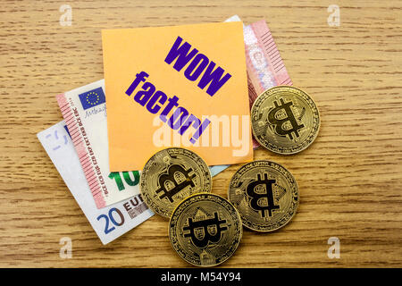 Bitcoins, Bit Coin on Euro, Dollars notes witch sticky note on wooden background, WOW factor. Bitcoin concept. Stock Photo