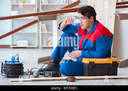 The young carpenter at work tired feeling not well Stock Photo