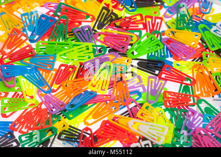 Closeup of Many Colored Paper Clips on White. Stock Photo