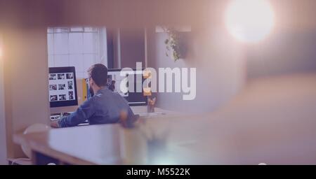 Man working in hazy glow room Stock Photo