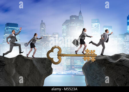 Business people chasing each other towards key to success Stock Photo