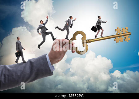 Business people chasing each other towards key to success Stock Photo