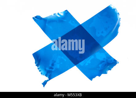 Cross of blue masking tape isolated on white background Stock Photo