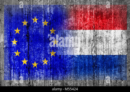 EU and Netherlands flag on concrete wall Stock Photo