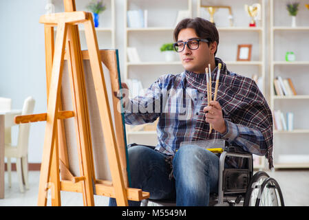 Disabled artist painting picture in studio Stock Photo