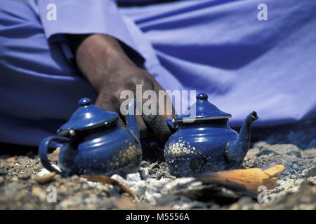 Algeria. Near Tamanrasset. Sahara desert. Man from Tuareg tribe preparing tea. Stock Photo