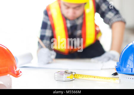 engineer sketch a construction plan on drawing paper Stock Photo