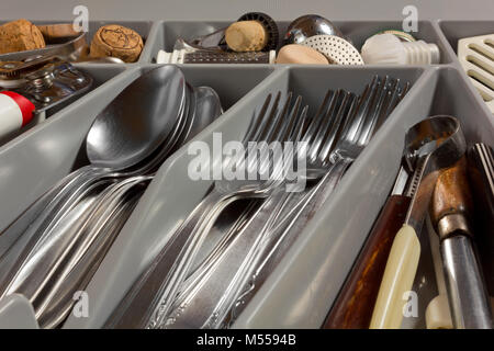 Close-up of the contents of a kitchen drawer full of cutlery and utensils Stock Photo