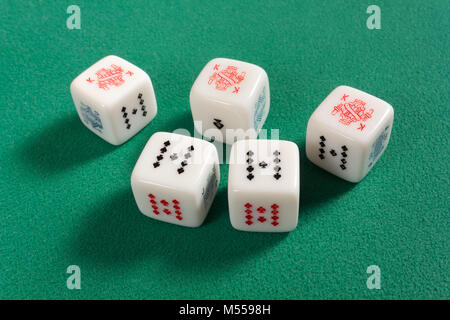 Poker dice on a green table with a full house Stock Photo