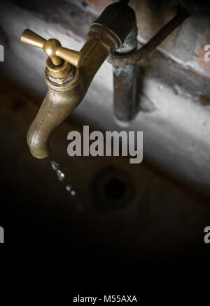 Old vintage brass water faucet Stock Photo