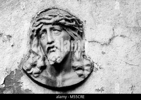 Face of Jesus Christ on old tombstone. Black and white image Stock Photo