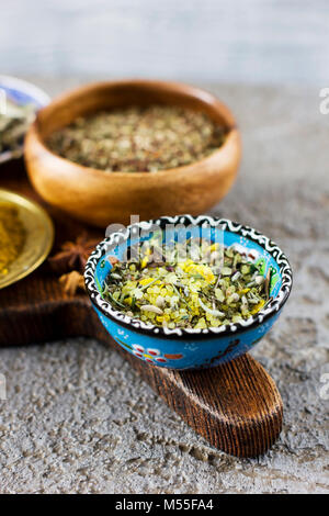 Lemon salt with Provencal herbs in a blue Cup on a wooden Board Stock Photo
