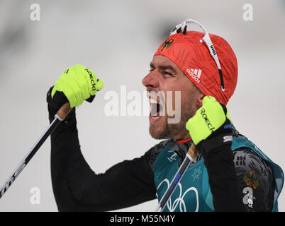 Pyeongchang, South Korea. 20th Feb, 2018. , Olympics, Nordic combined, cross-country skiing, Alpensia Ski Jump Centre: Johannes Rydzek, who won gold, celebrating at the finish line. Credit: dpa picture alliance/Alamy Live News Stock Photo