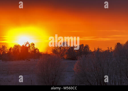 Colorful sunset over a cold wintry rural landscape Stock Photo