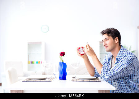 Man alone preparing for romantic date with his sweetheart Stock Photo