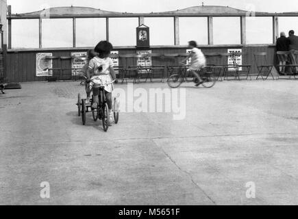 1930s, historical, childrern cycling outdoor in a special area on a seaside pier, England. Stock Photo