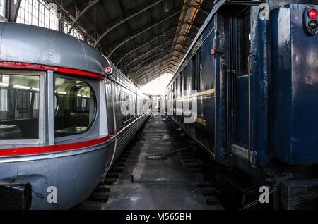 Madrid, Spain. Sep. 29, 2015. Vanishing point on two vintage trains at the Madrid railroad museum. Trenes en el museo del ferrocarril de Madrid. Stock Photo