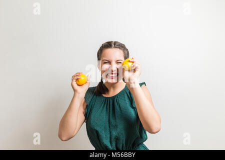 Very happy smiling woman took lemons of the tree Stock Photo