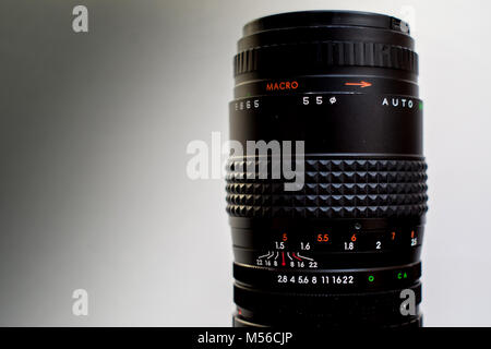 camera lenses laying on white wooden background Stock Photo