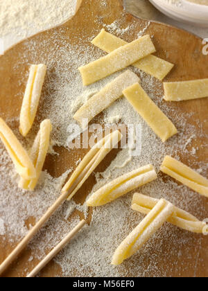 Traditional Italaian Casarecce pasta being made in a rustic setting Stock Photo