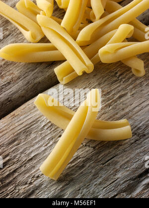 Traditional dried  Italian Casarecce pasta close up in a rustic setting on wood Stock Photo